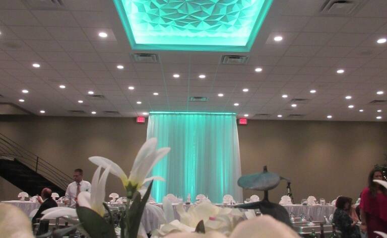 Close up of floral arrangements with teal lighting in Balconade Room