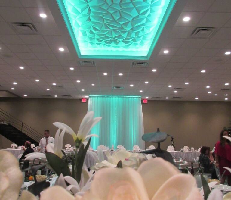Close up of floral arrangements with teal lighting in Balconade Room