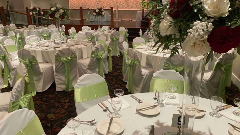 Terrace Room Event Setup with Green Sash Chair Covers