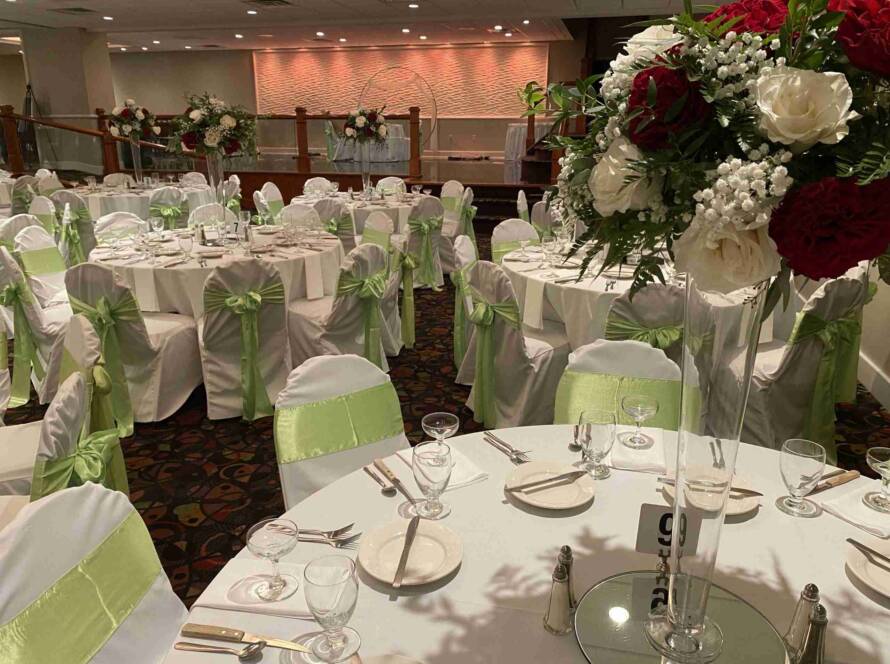 Terrace Room Event Setup with Green Sash Chair Covers