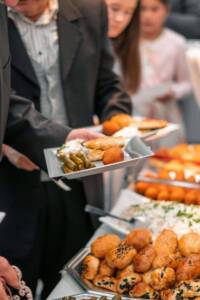 group of business people getting food from a buffet during a corporate event